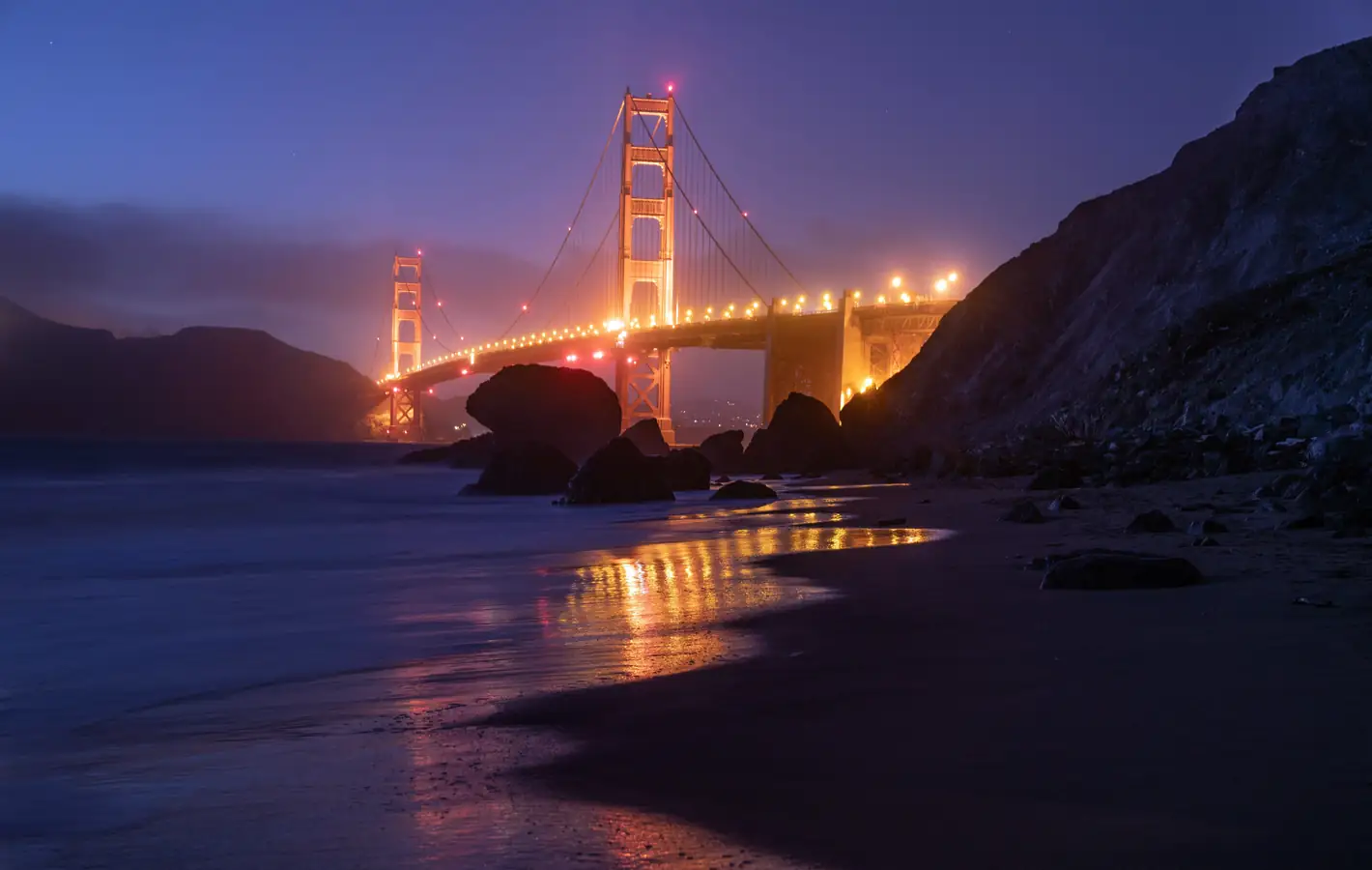 Golden Gate Bridge illuminated at night — desktop and phone wallpaper, free download