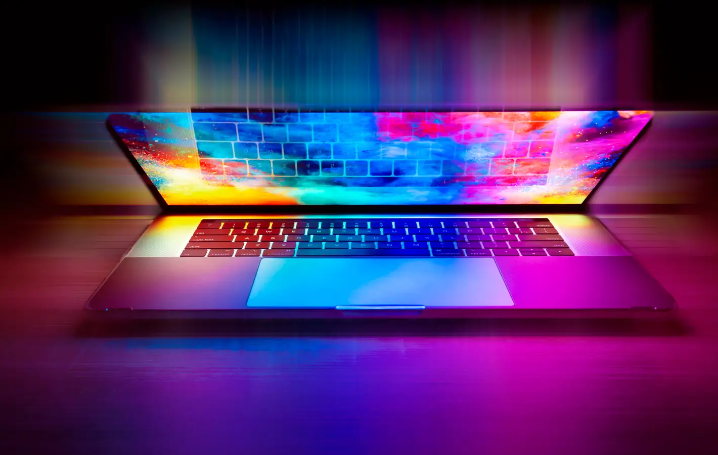 Macbook with vibrant colorful screen light — desktop and phone wallpaper, free download