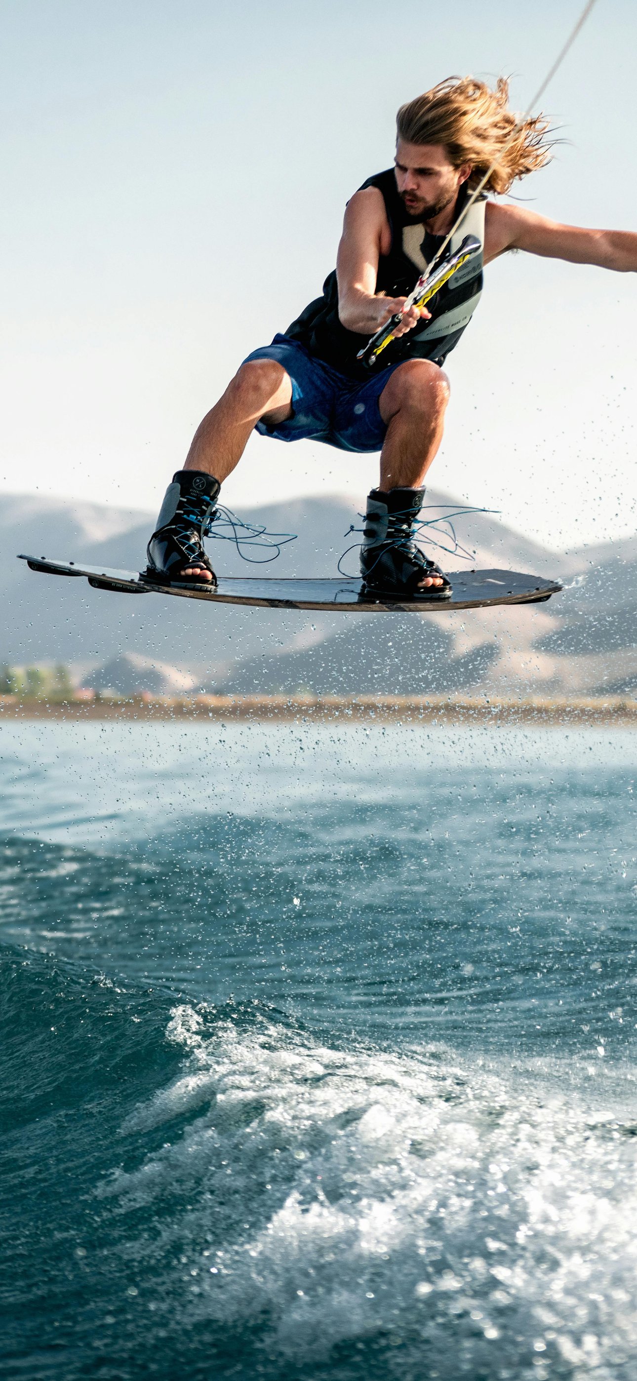 Wakeboarder jumping over waves - Wallpapers for iPhone 15 Pro Max/14 Pro Max in 1290x2796 resolution
