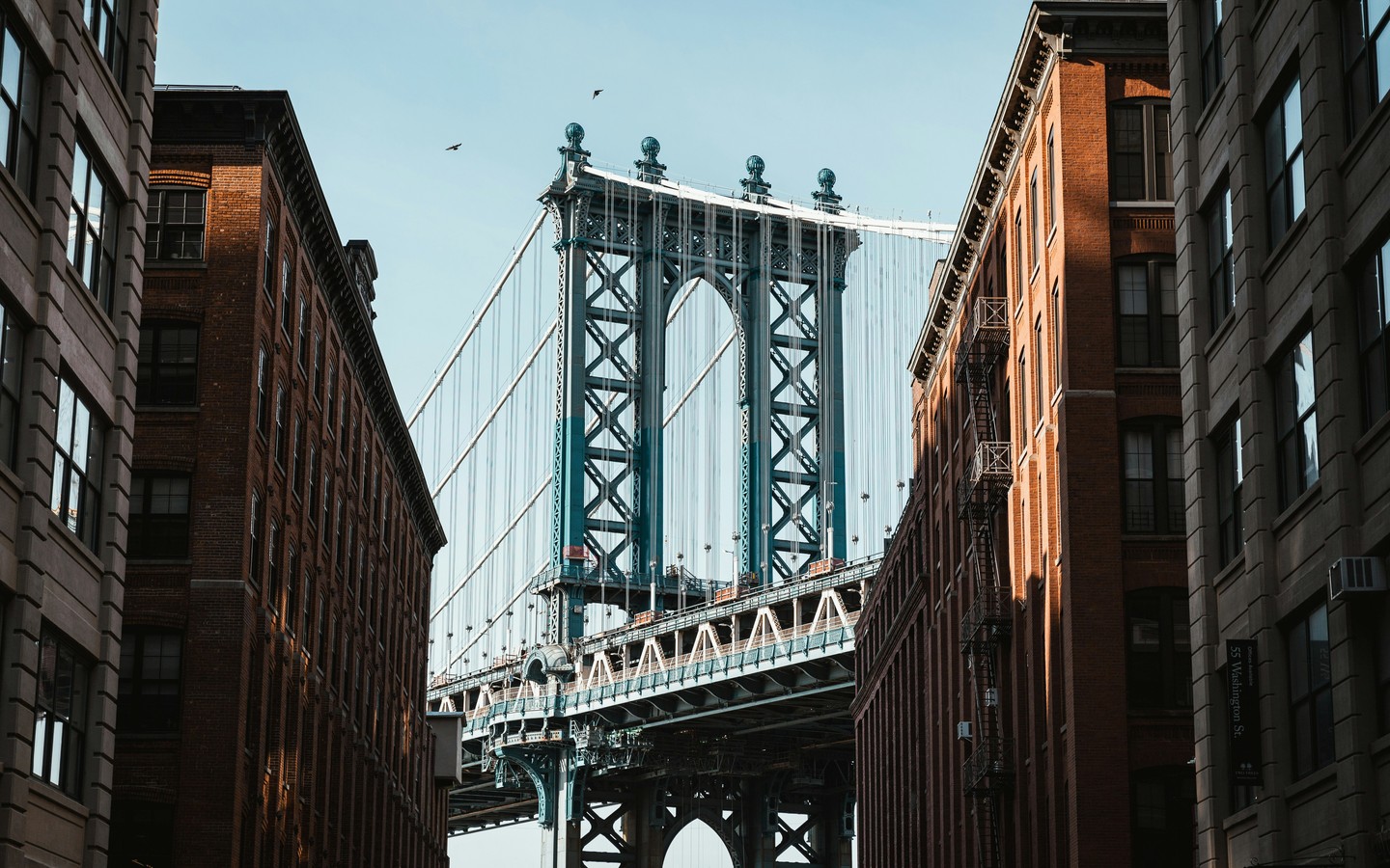 Stunning View of Brooklyn Bridge Between Buildings in Dumbo