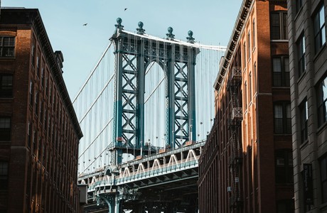 Stunning View of Brooklyn Bridge Between Buildings in Dumbo