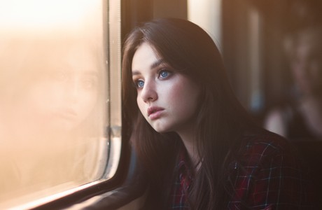 A Thoughtful Young Woman Traveling by Train