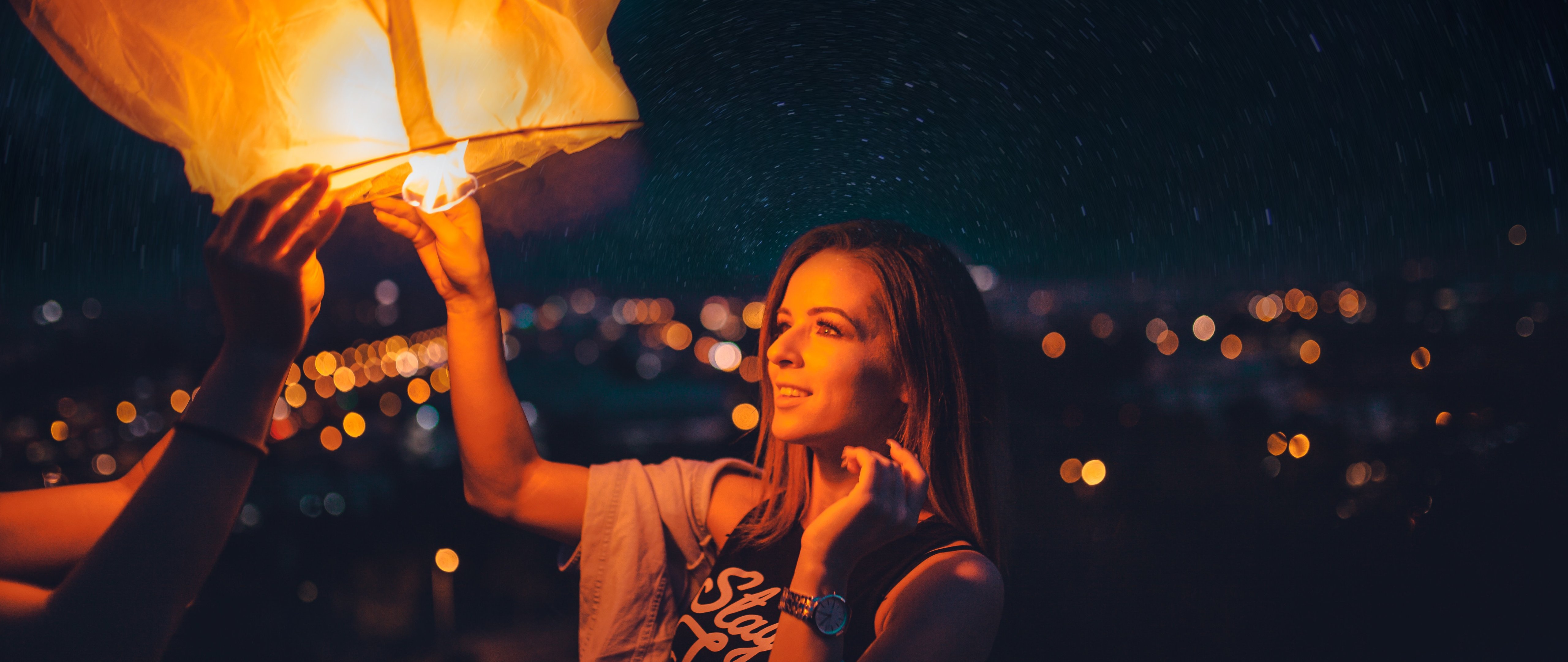 Woman lighting sky lantern at night - 5K2K UltraWide 21:9 wallpapers in 5120x2160 resolution