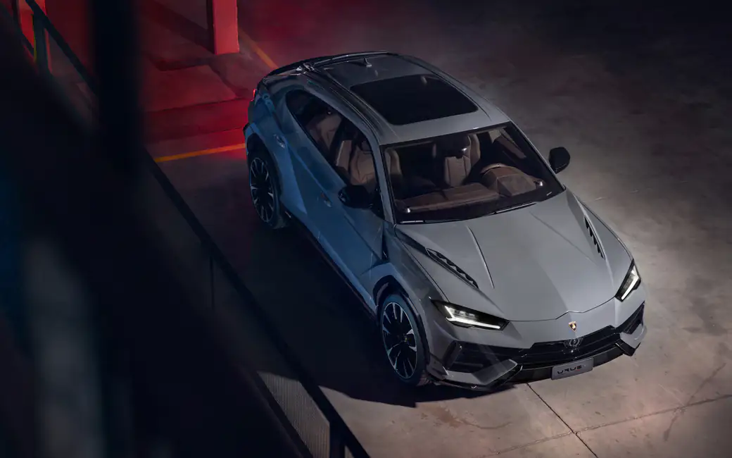 Lamborghini Urus S in modern parking garage — desktop and phone wallpaper, free download