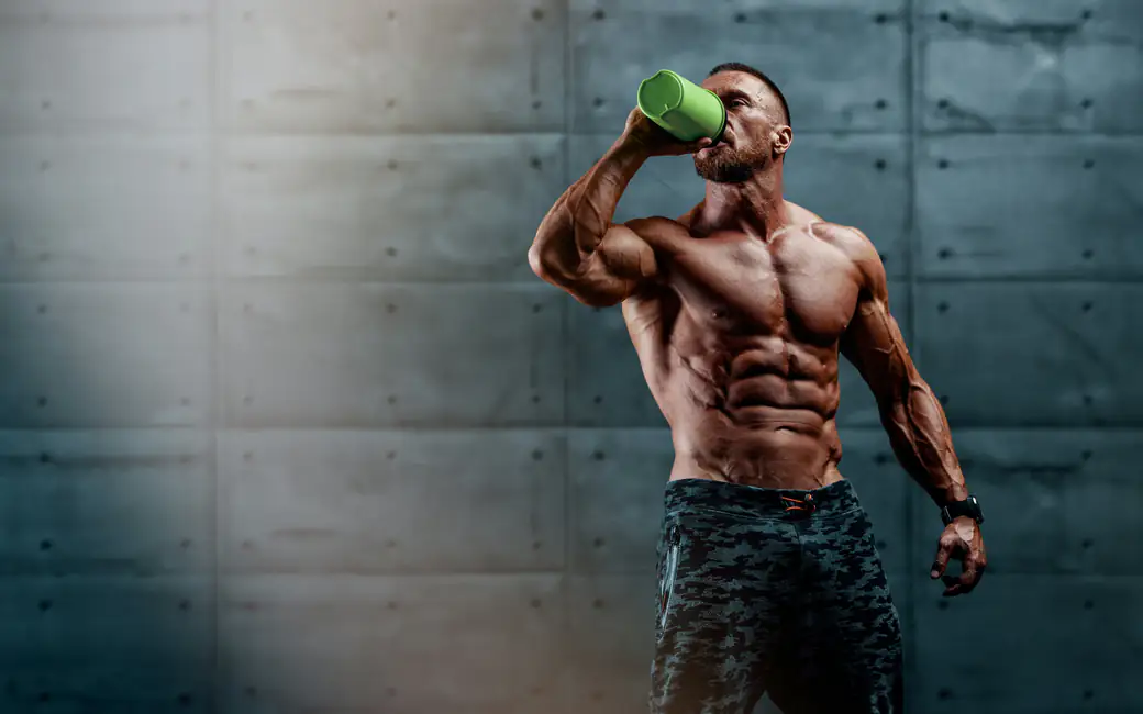 Muscular bodybuilder drinking shake — desktop and phone wallpaper, free download