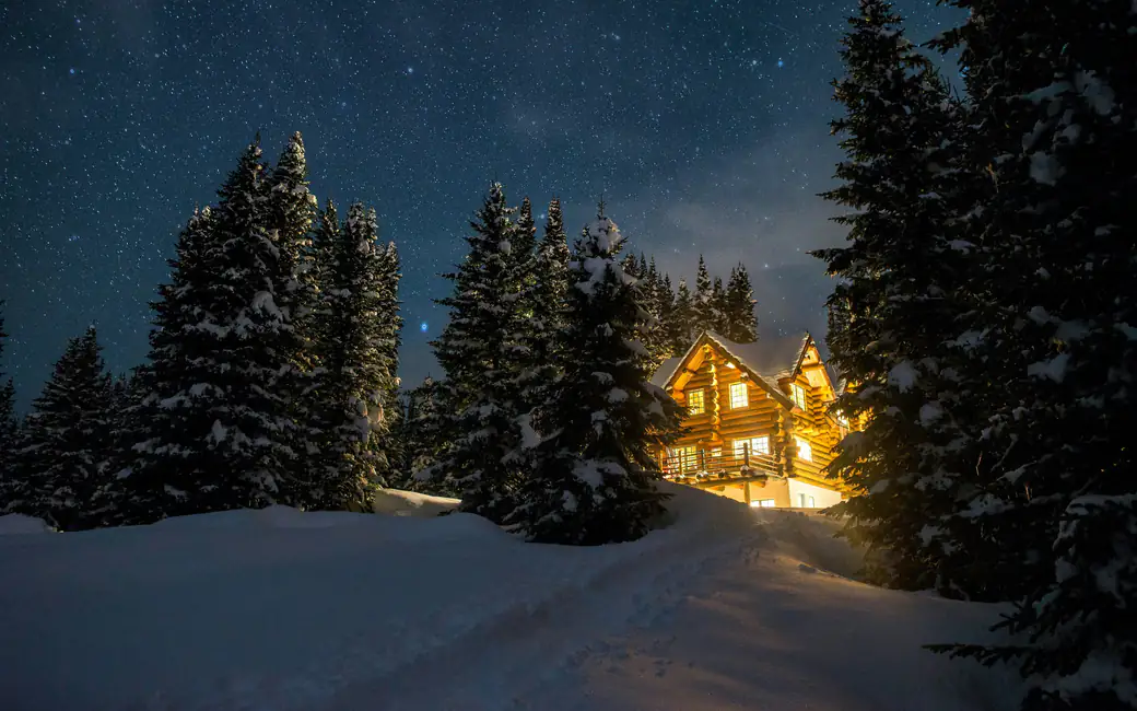 Cozy house in the woods in winter — desktop and phone wallpaper, free download