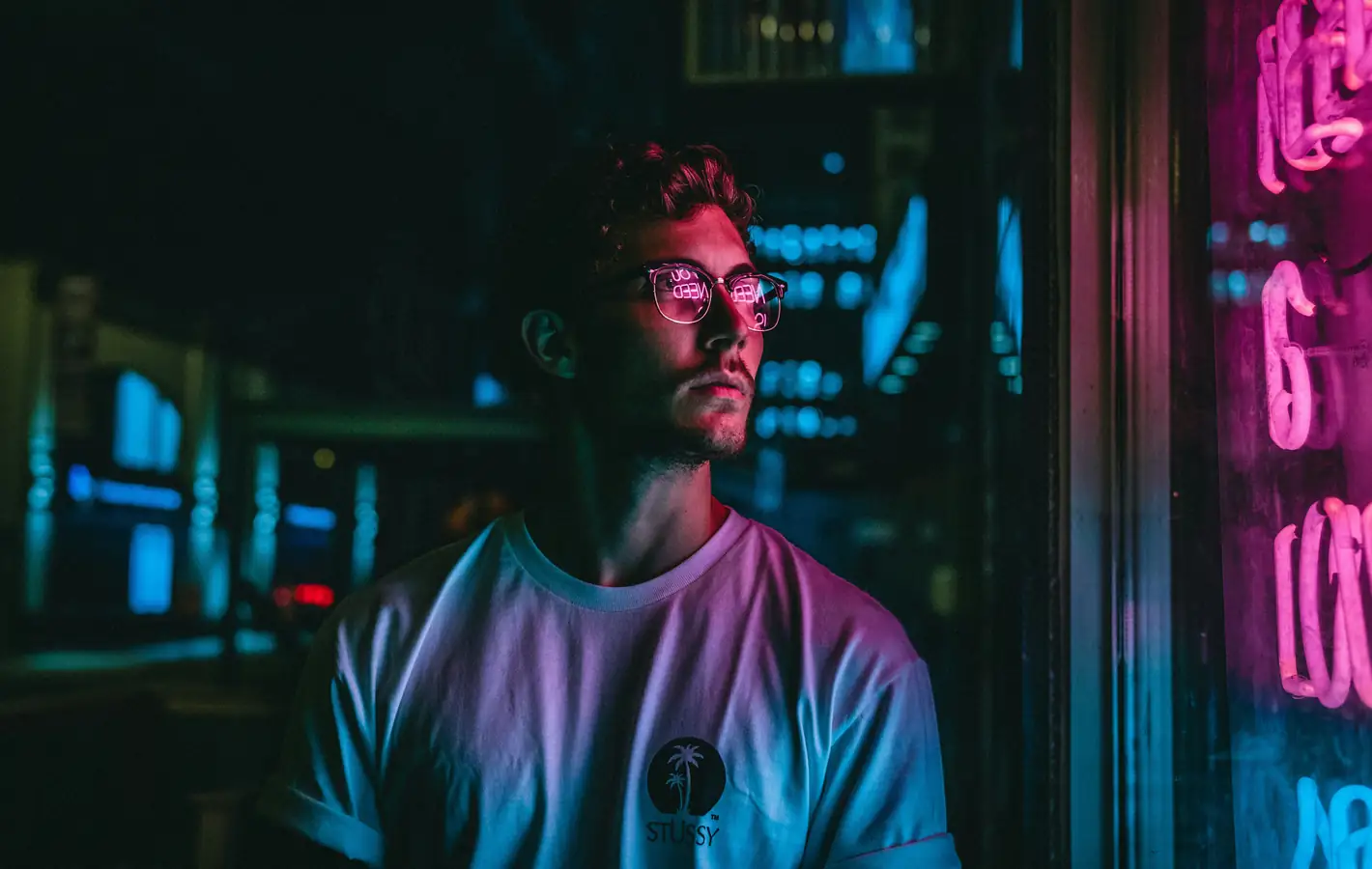 A man with glasses in a neon light — desktop and phone wallpaper, free download