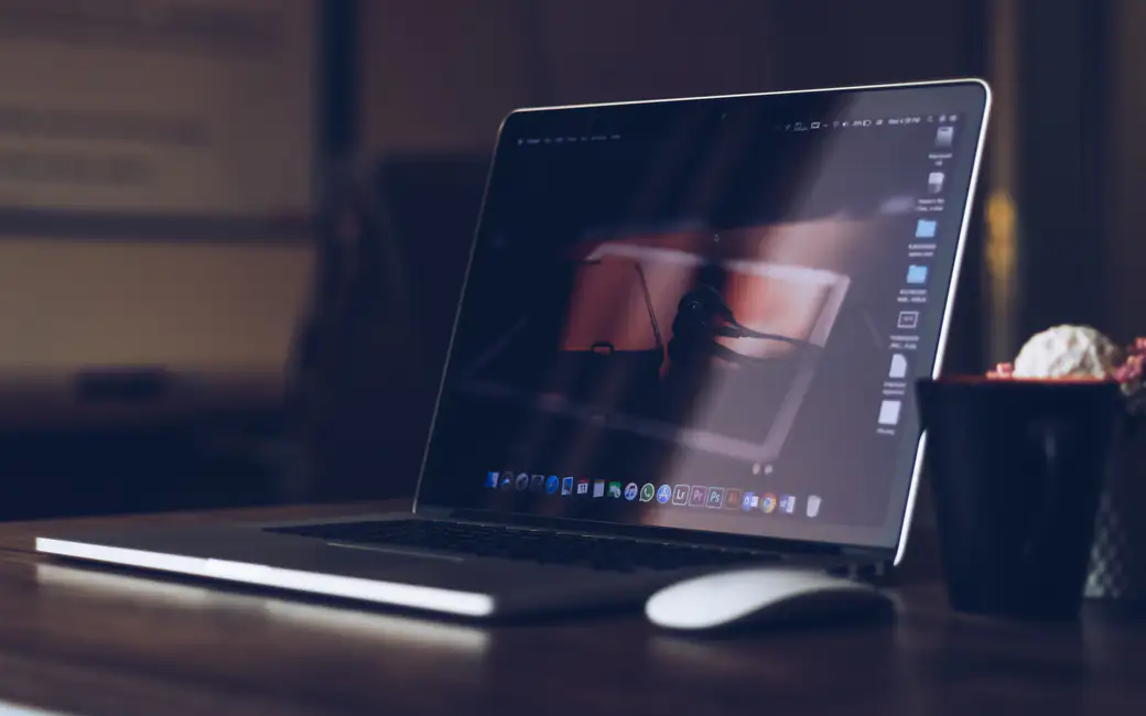 Apple MacBook on wooden desk — desktop and phone wallpaper, free download