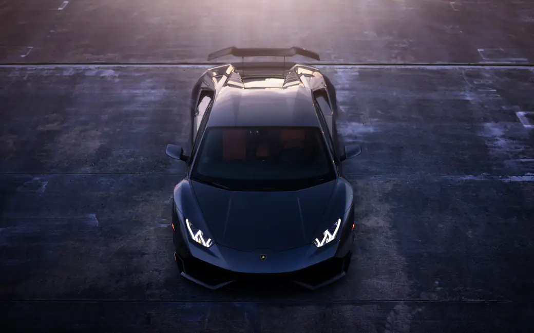 Black Lamborghini Huracán in the parking lot — desktop and phone wallpaper, free download