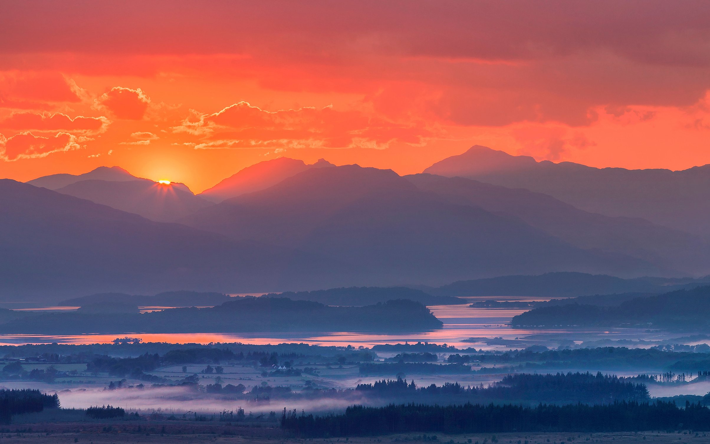 Bright orange sunrise over the valley - Wallpapers for MacBook Neo in 2408x1506 resolution