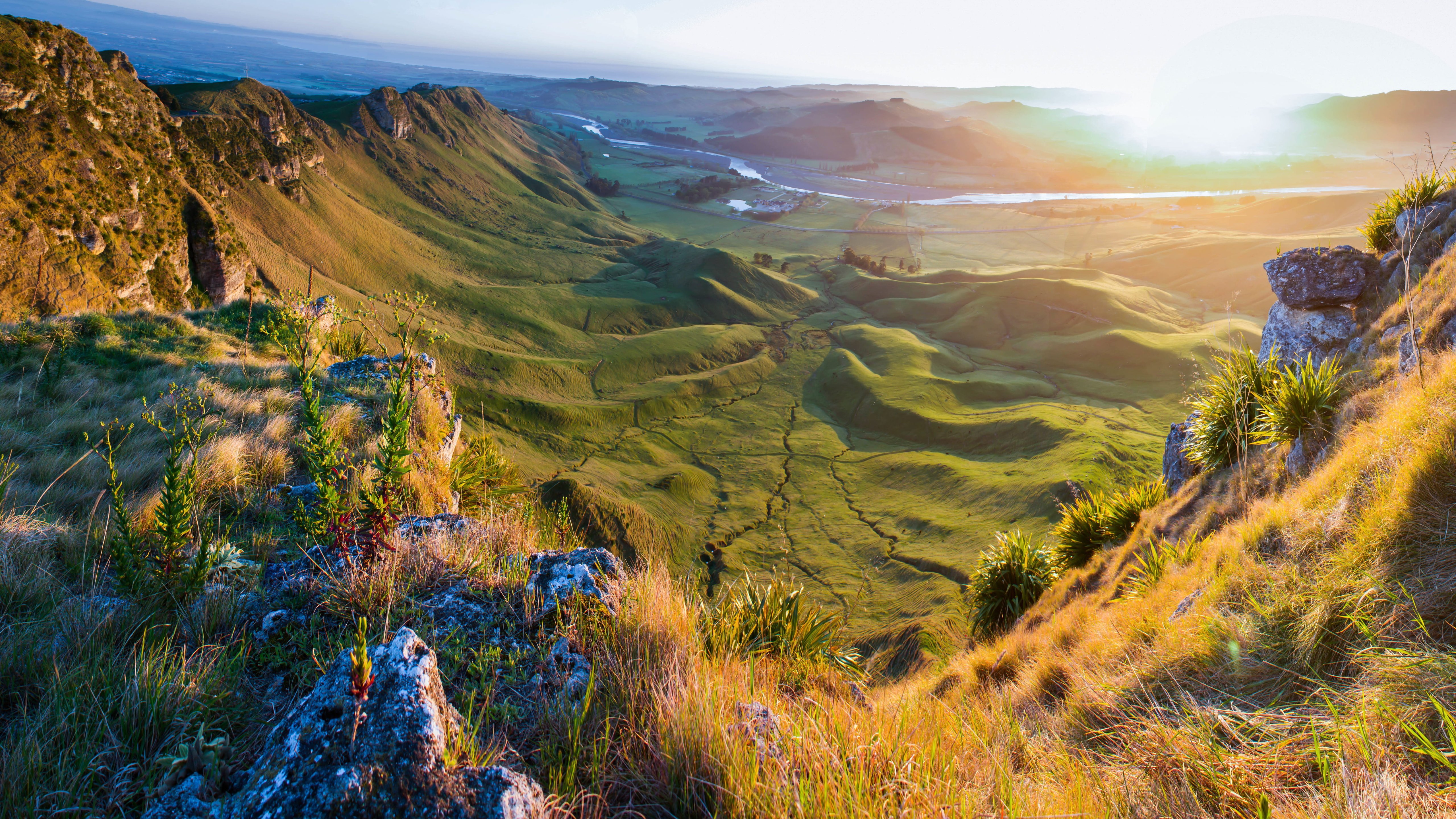 Sunset over rocky mountain valley with green fields - 5K wallpapers in 5120x2880 resolution