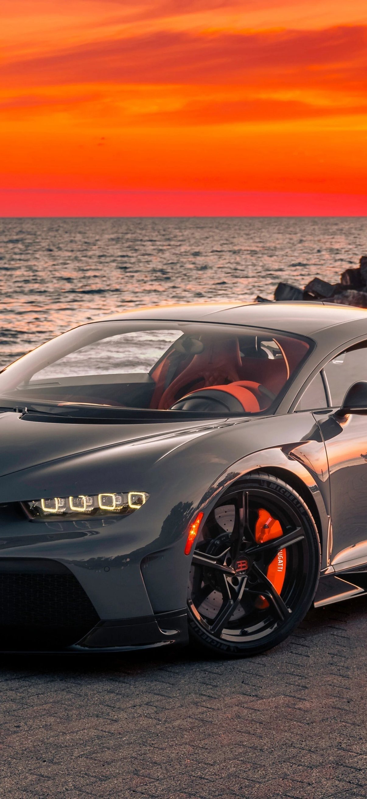 Bugatti Chiron parked by ocean sunset - Wallpapers for iPhone 18 Pro/18/17 Pro/17/16 Pro in 1206x2622 resolution