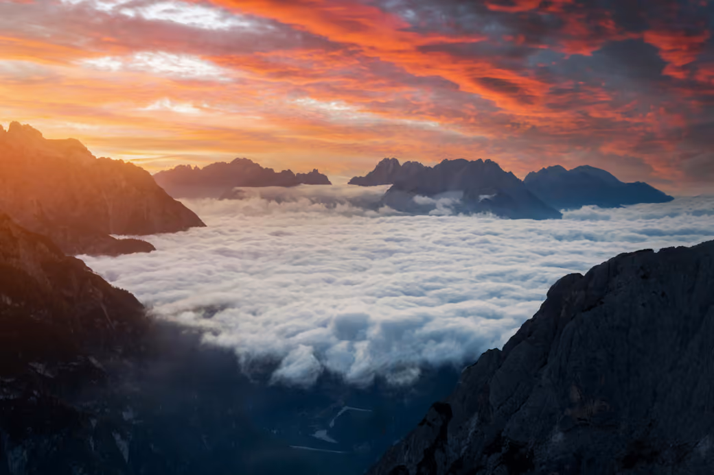 Mountains and valley in clouds at sunset — desktop and phone wallpaper, free download