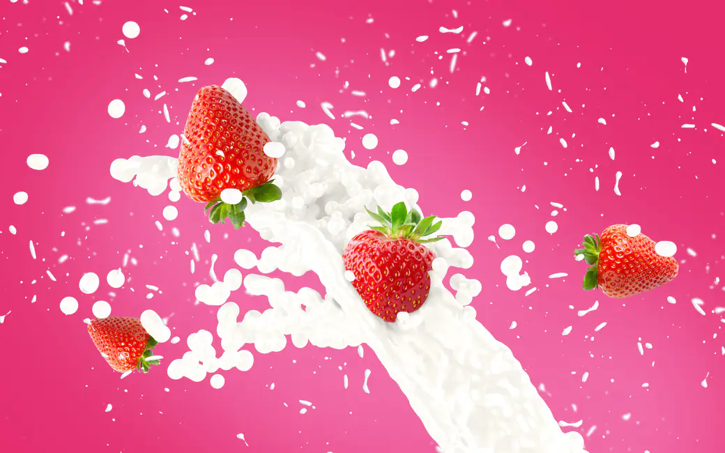 Fresh strawberries splashing in cream — desktop and phone wallpaper, free download