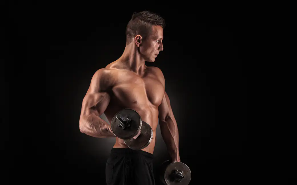 Muscular man lifts dumbbells — desktop and phone wallpaper, free download
