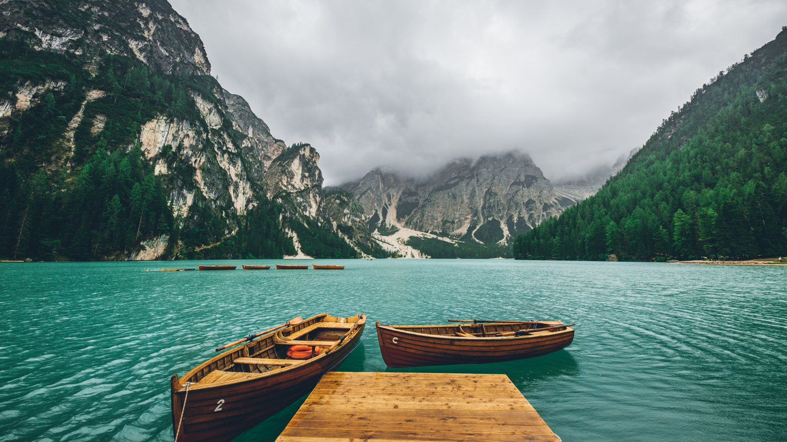 Turquoise lake with wooden boats - wXGA++ wallpapers in 1600x900 resolution
