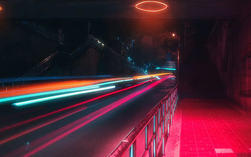 Neon light trails at night in the city — desktop and phone wallpaper, free download