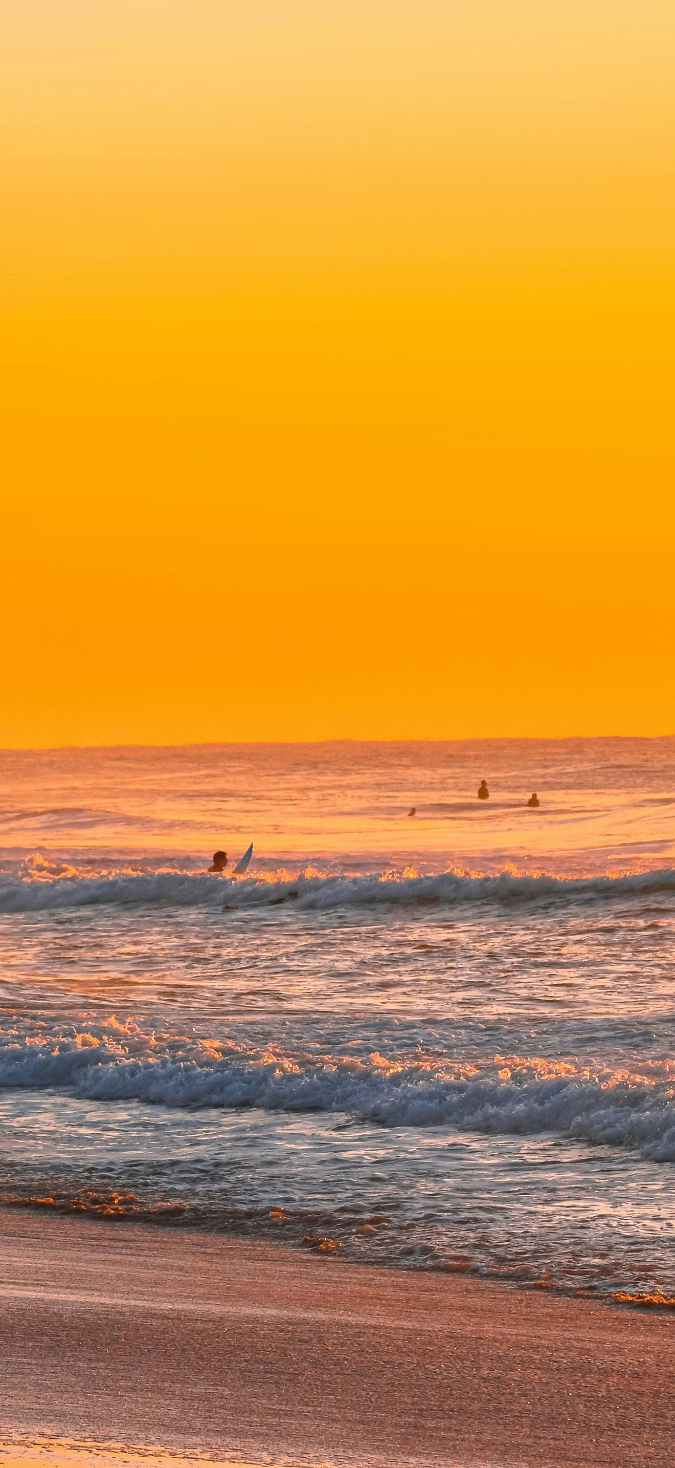 Beach with waves in an orange sunset - Wallpapers for iPhone 17 Pro Max/16 Pro Max in 1320x2868 resolution