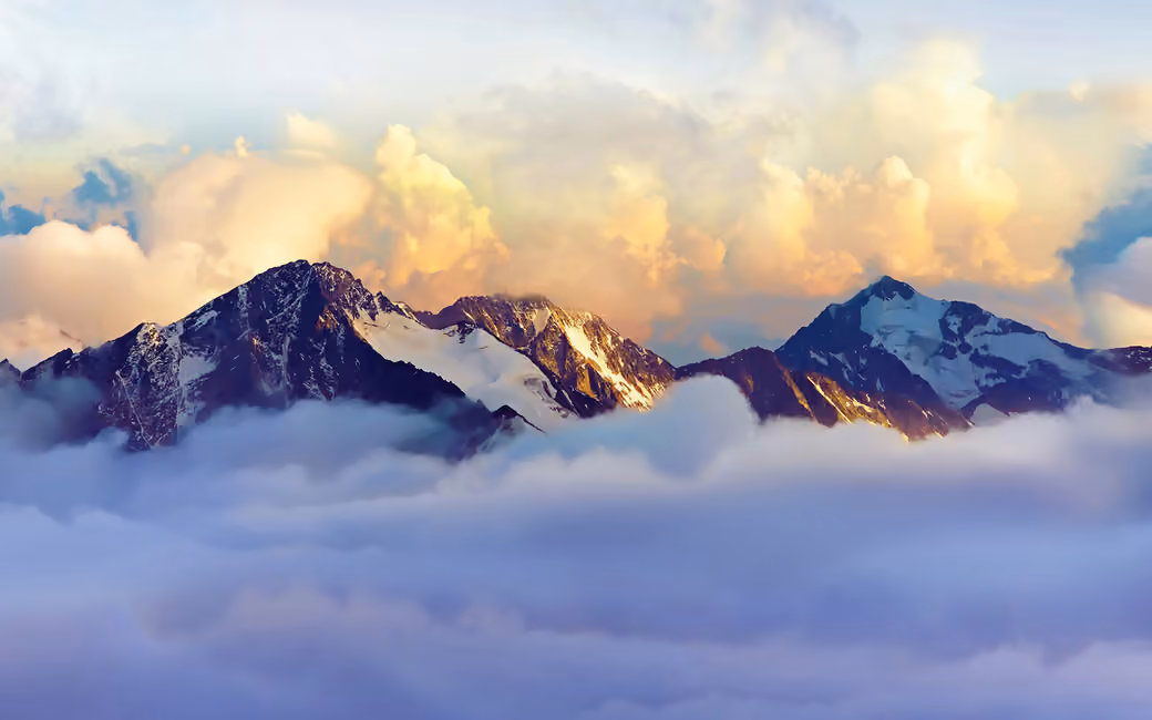 Alps snow-capped peaks above clouds — desktop and phone wallpaper, free download
