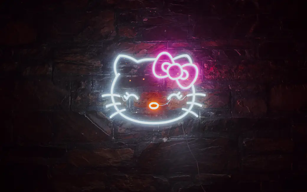 Neon Hello Kitty logo on the wall — desktop and phone wallpaper, free download
