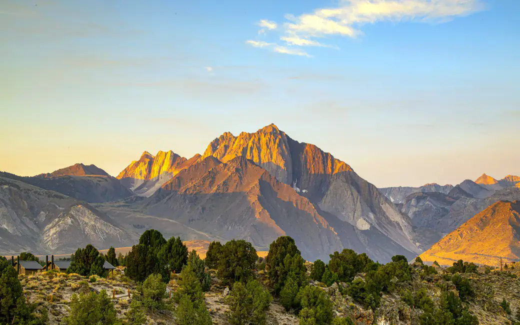 Mountains and valley in a yellow sunset — desktop and phone wallpaper, free download