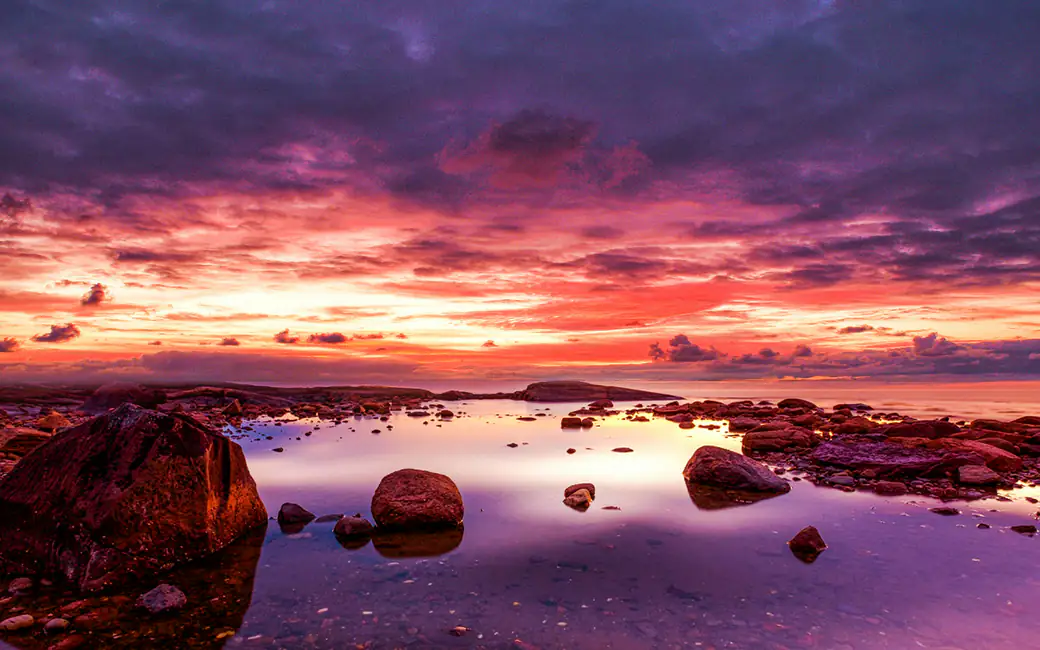 Red Evening Sunset Over Coastal Stones — desktop and phone wallpaper, free download