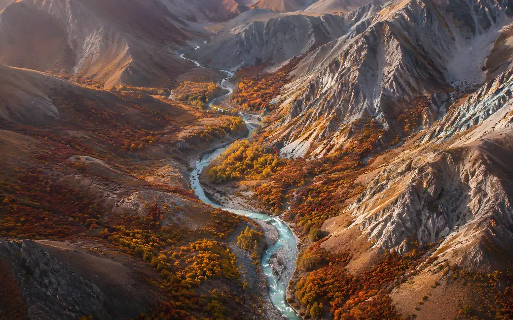 Mountain canyon with a stream in autumn — desktop and phone wallpaper, free download