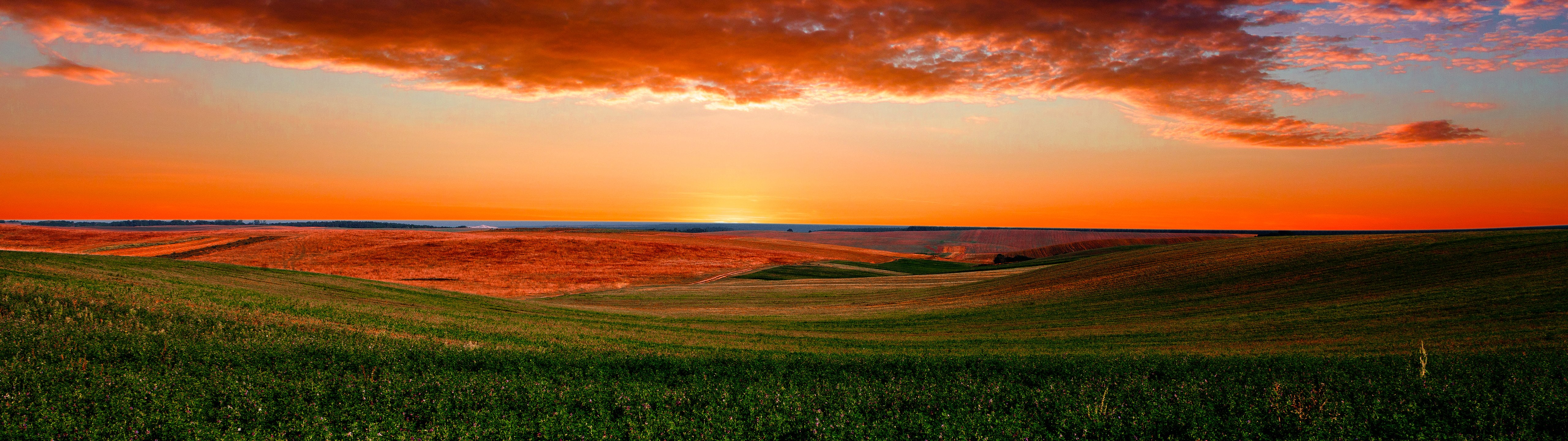 Colorful sunset over a green field - UltraWide 32:9 wallpapers in 5120x1440 resolution