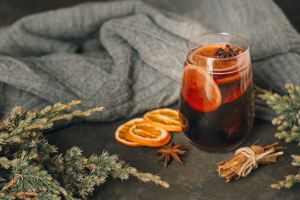 Warm mulled wine in a clear glass — desktop and phone wallpaper, free download