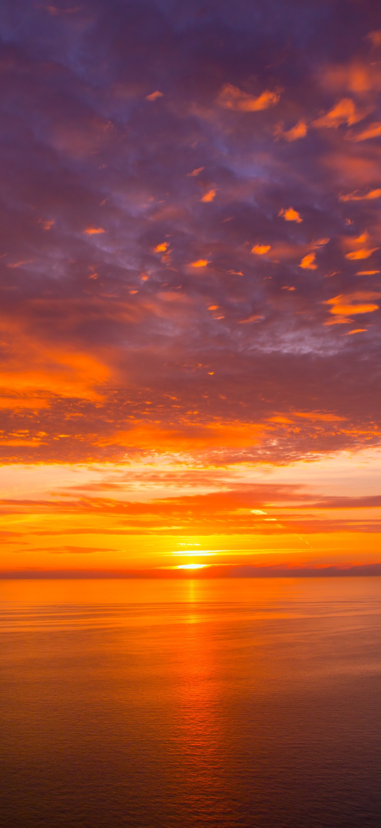 Orange sunset over a calm sea - Wallpapers for iPhone Air in 1260x2736 resolution
