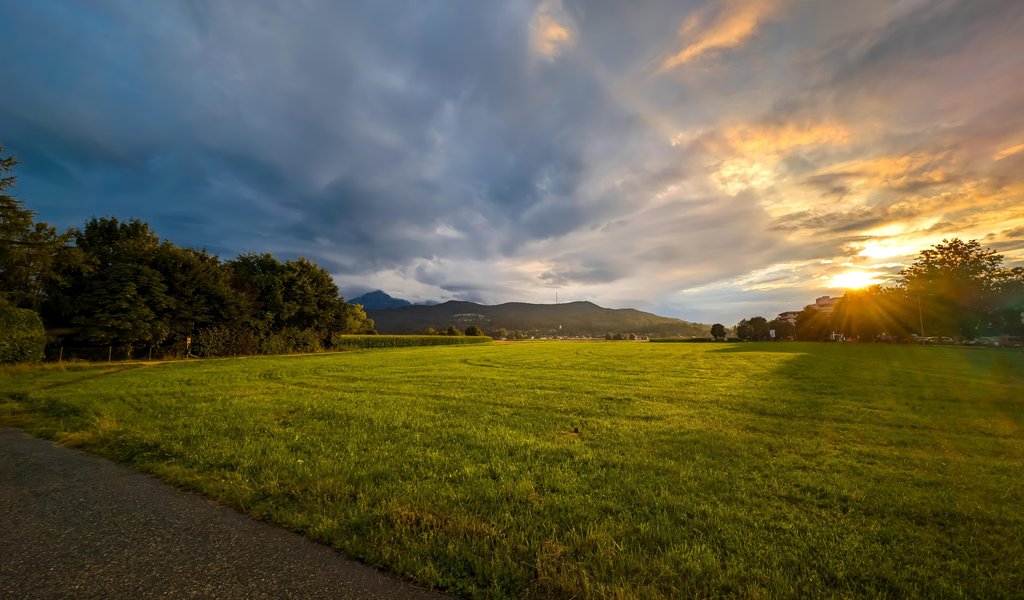 Sunset panorama over a green field - WSVGA wallpapers in 1024x600 resolution