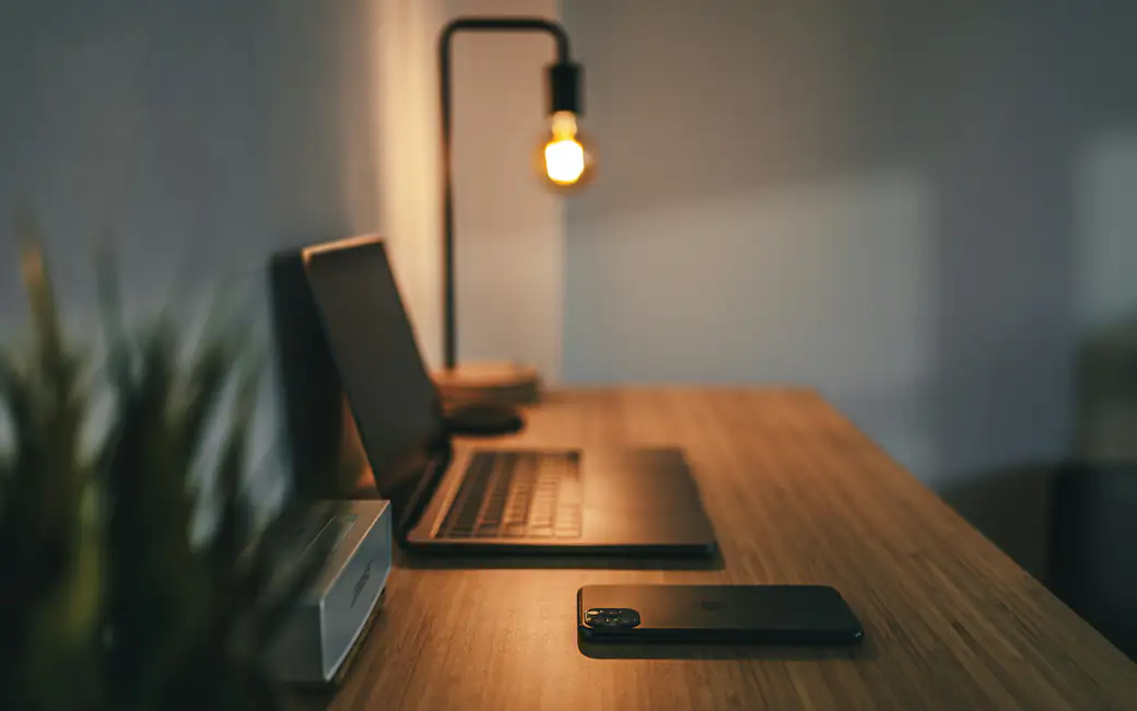 Cozy workplace with a lamp — desktop and phone wallpaper, free download