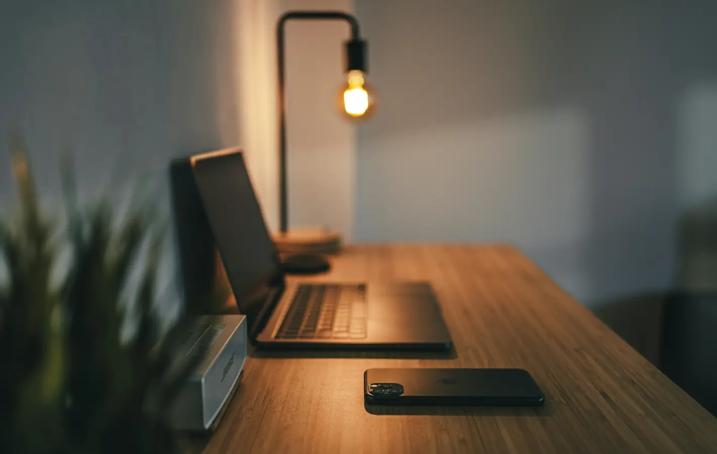 Cozy workplace with a lamp — desktop and phone wallpaper, free download